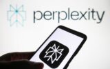 Perplexity AI logo is seen on a smartphone and on a PC screen.