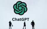 This photograph taken in Mulhouse, eastern France on October 19, 2023, shows figurines next to the ChatGPT logo. (Photo by SEBASTIEN BOZON/AFP via Getty Images)