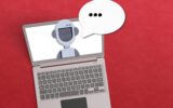AI agent concept with robot inside a laptop with a voice bubble on red background.