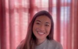 The COO of Bluesky, Rose Wang, sits in her home office with a pink curtain backdrop