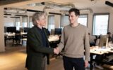 French CEO of AFP (Agence France Presse) Fabrice Fries (L) shakes hands with French founder of artificial intelligence start-up Mistral AI, Arthur Mensch at the Mistral headquarters in Paris, on January 15, 2025. AFP (Agence France-Presse) and Mistral have signed an agreement that allows the conversational robot of the French start-up that aims to become Europe's leading AI player to use the agency's news dispatches to answer its users' queries, they announced on January 16, 2025.