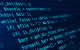 Blue code on a dark background presented at an angle.